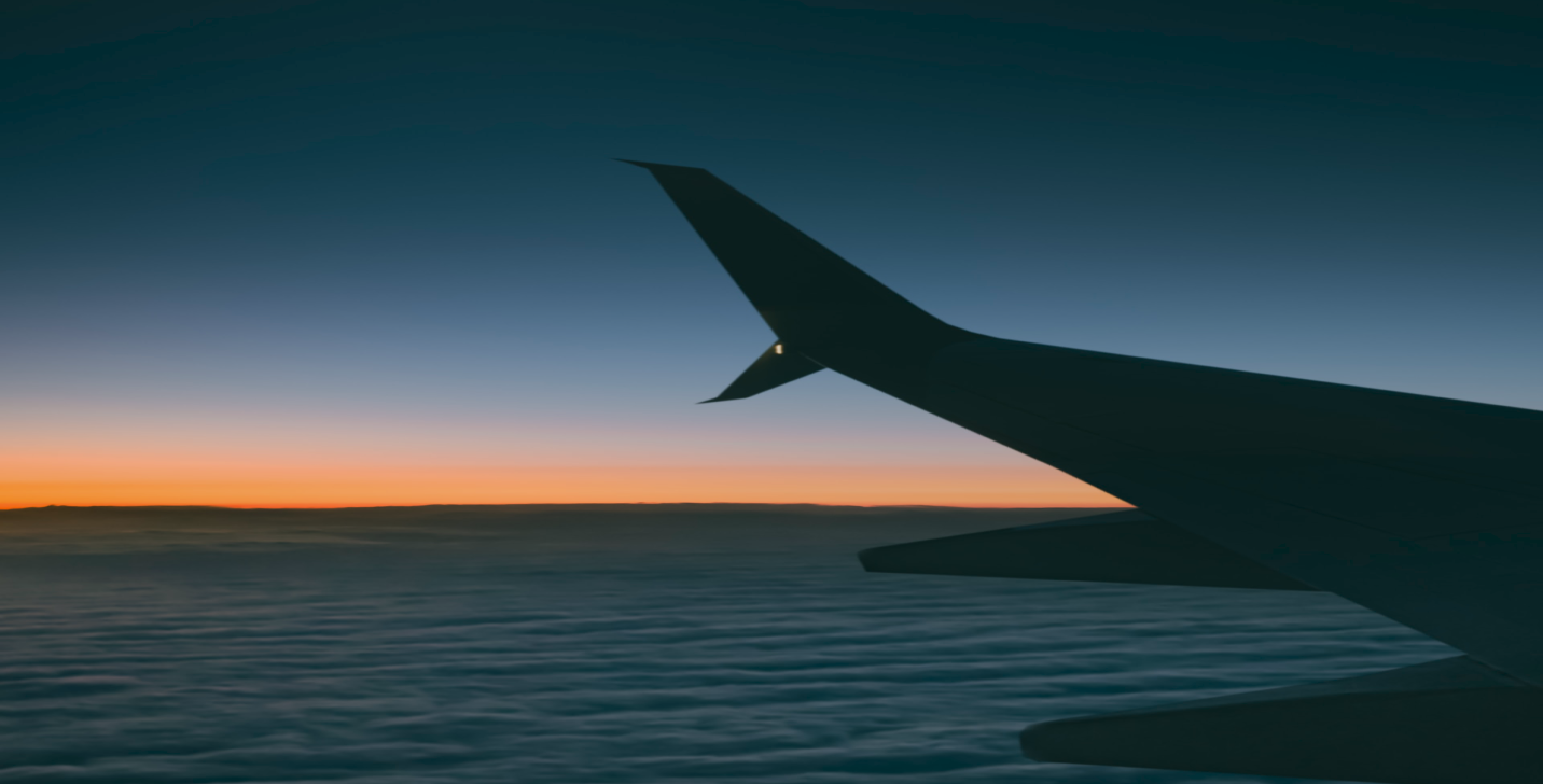 jet airliner landing on runway in the evening